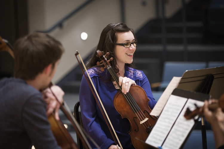 Girl smiling with violin 750x500